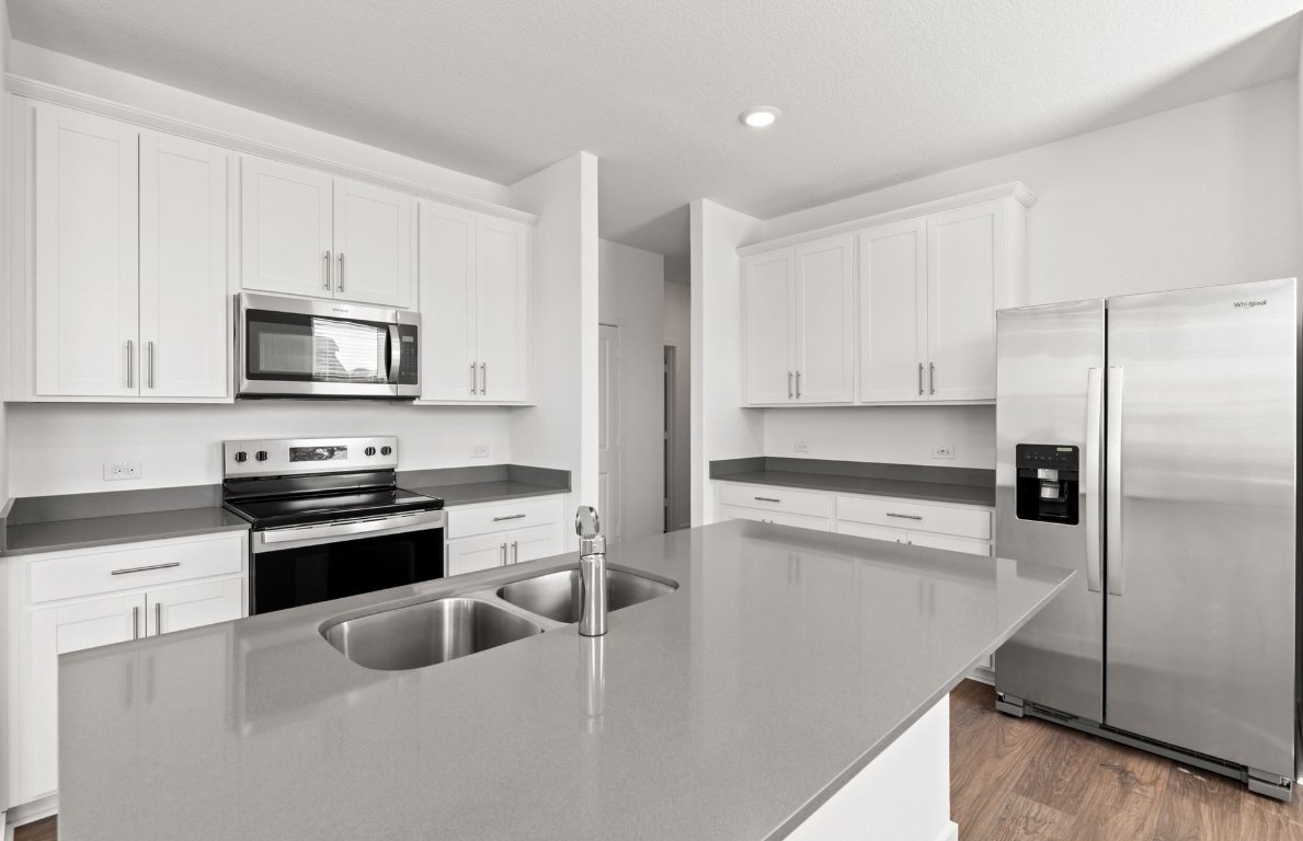 401 The Duke Drive Jarrell, TX 76537 - Photo 5 of 25 a kitchen with cabinets stainless steel appliances and a counter space