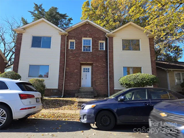 a front view of a house with parking space