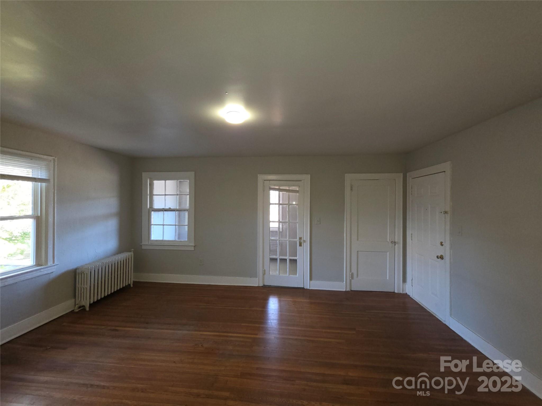 1412 Park Drive, Unit 4 Charlotte, NC 28204 - Photo 2 of 14 an empty room with window and wooden floor