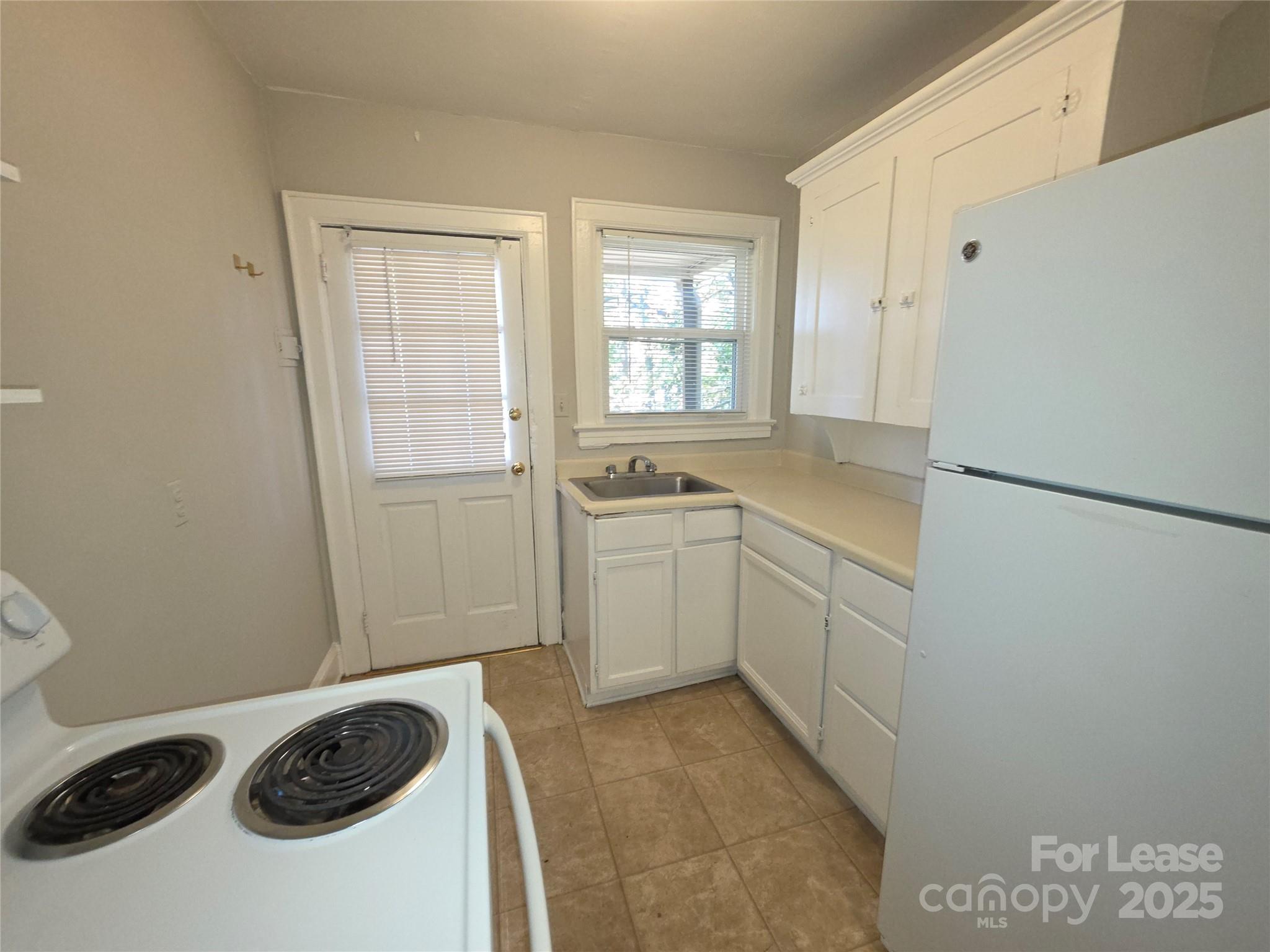 1412 Park Drive, Unit 4 Charlotte, NC 28204 - Photo 7 of 14 a kitchen with a sink a stove and cabinets