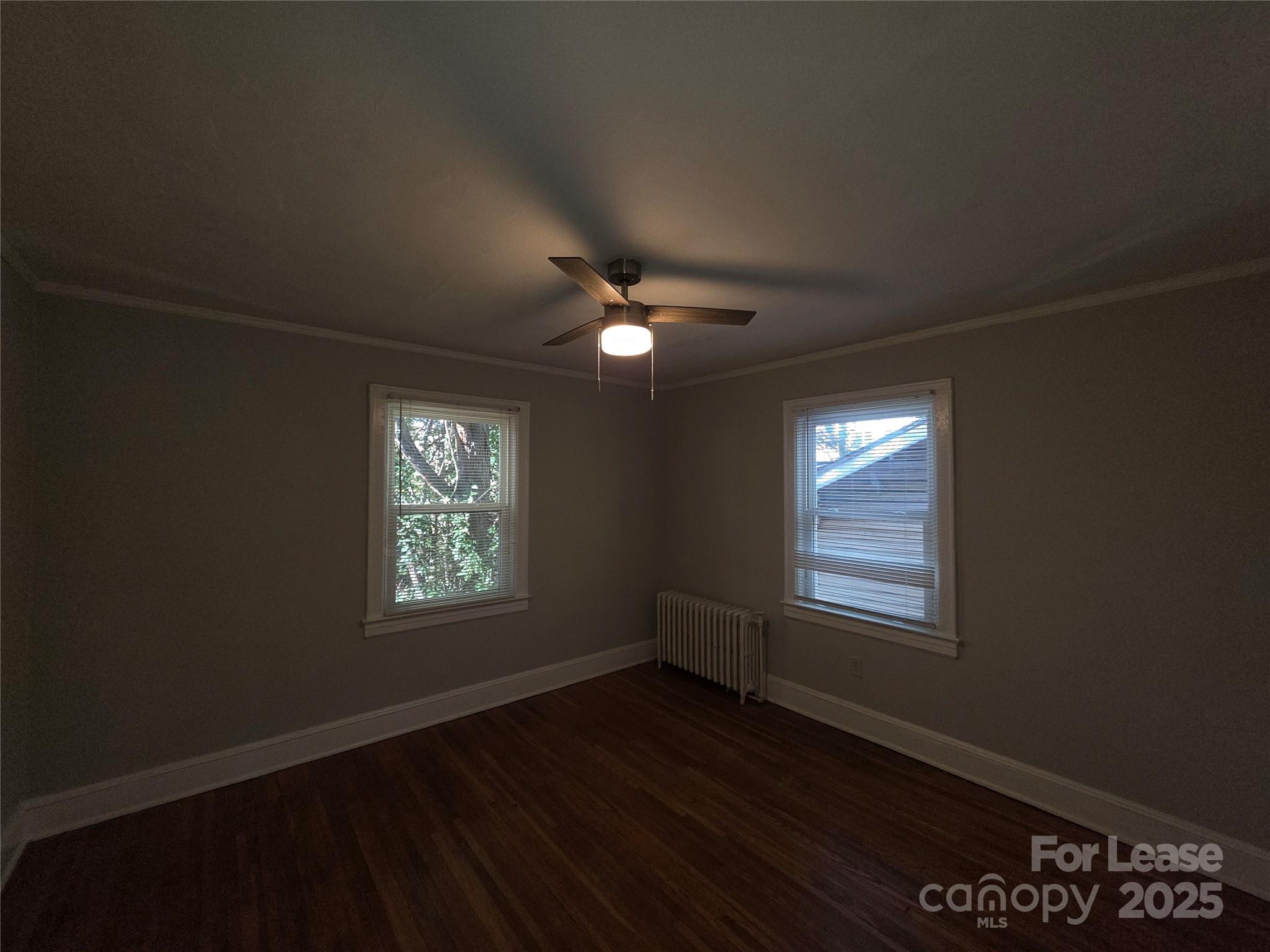 1412 Park Drive, Unit 4 Charlotte, NC 28204 - Photo 9 of 14 a view of an empty room with wooden floor and a window