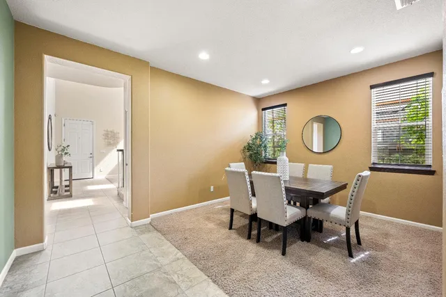 a view of a livingroom with furniture and a mirror