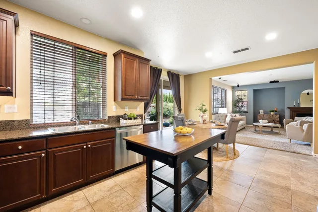 a kitchen with granite countertop a sink and a window