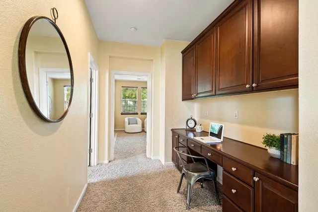 a workspace with a table chair and entryway