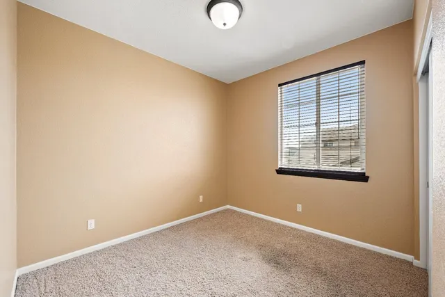 an empty room with windows and entrance