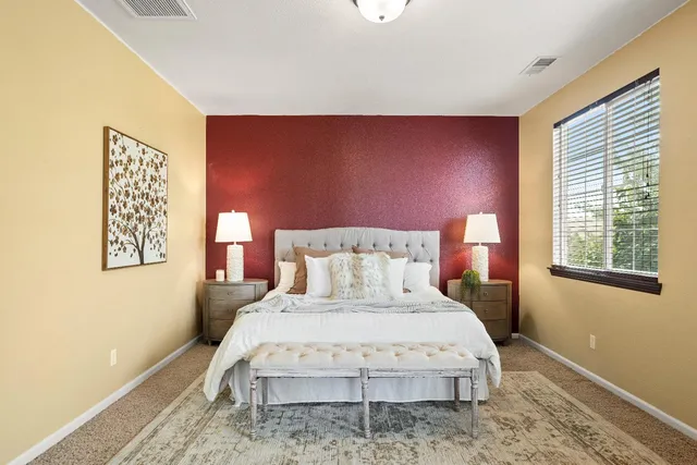 a bedroom with a bed and a night stand