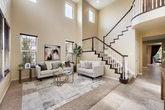 a living room with furniture and stairs