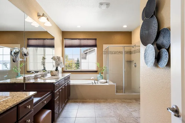 a bathroom with a tub sink and mirror
