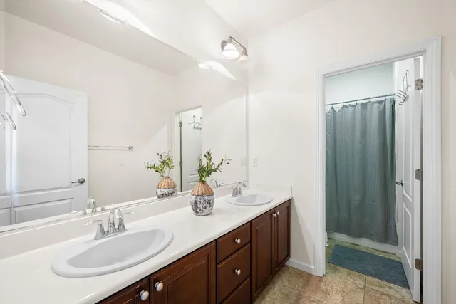 a bathroom with a sink double vanity and a mirror