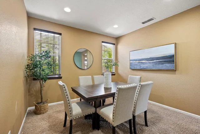 a dining room with furniture and wooden floor