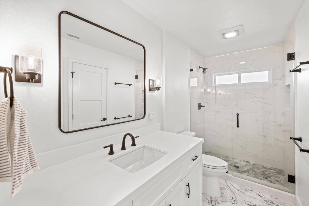 29086 Laurel Valley Drive Vista, CA 92084 - Photo 22 of 39 a bathroom with a sink a toilet and shower