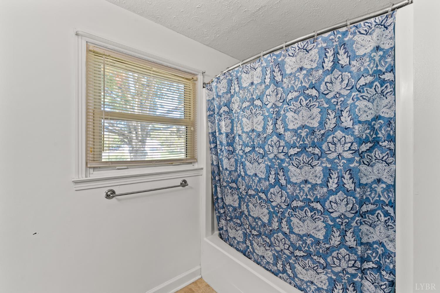 212 Ogden Road Altavista, VA 24517 - Photo 11 of 26 a bathroom with a shower curtain