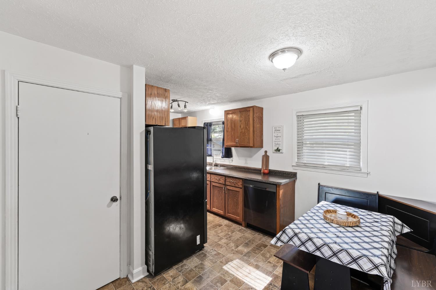 212 Ogden Road Altavista, VA 24517 - Photo 4 of 26 a kitchen with a refrigerator and a stove top oven