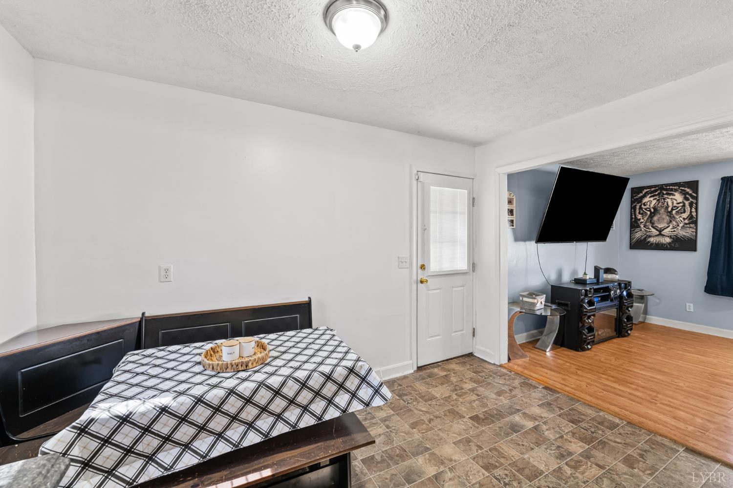 212 Ogden Road Altavista, VA 24517 - Photo 5 of 26 a bedroom with a bed and flat tv screen on a dresser