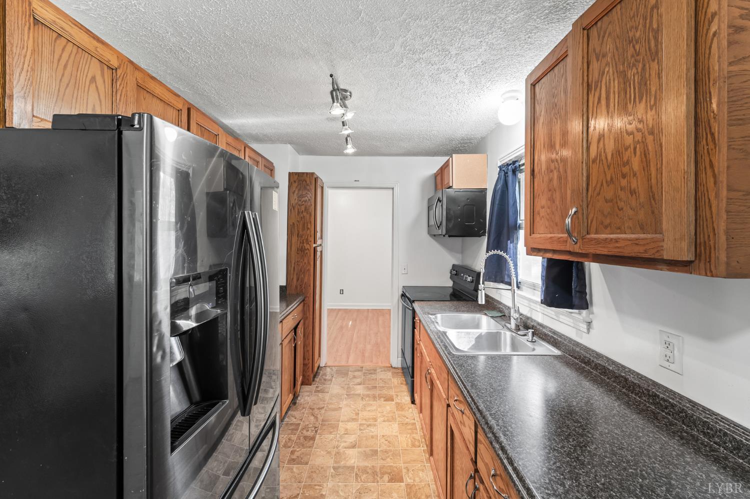 212 Ogden Road Altavista, VA 24517 - Photo 6 of 26 a kitchen with stainless steel appliances granite countertop a refrigerator and a sink