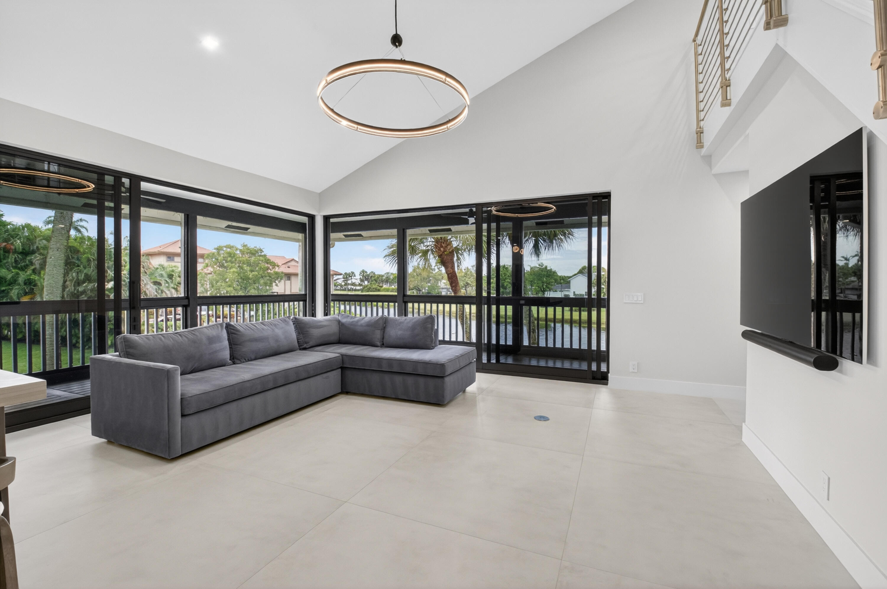 19221 Sabal Lake Drive, Unit 5124 Boca Raton, FL 33434 - Photo 15 of 98 a living room with furniture tv and a large window