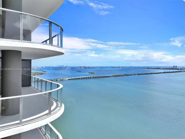 a large white room with double vanity and mirrors