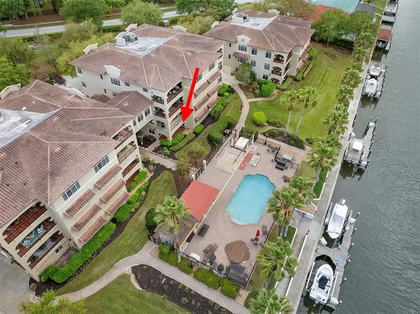 an aerial view of a house with a yard and outdoor seating