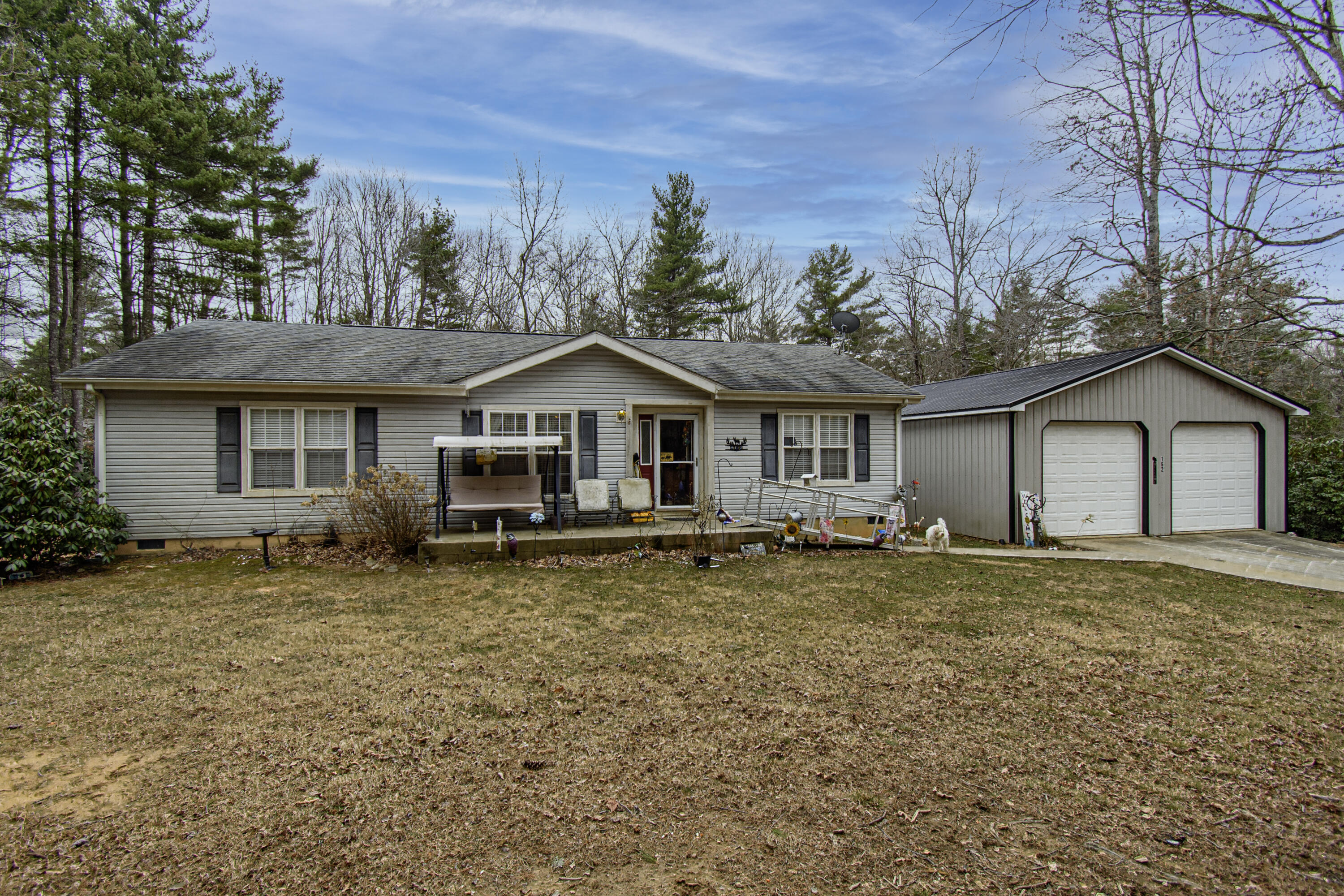 a front view of a house with a garden and trees