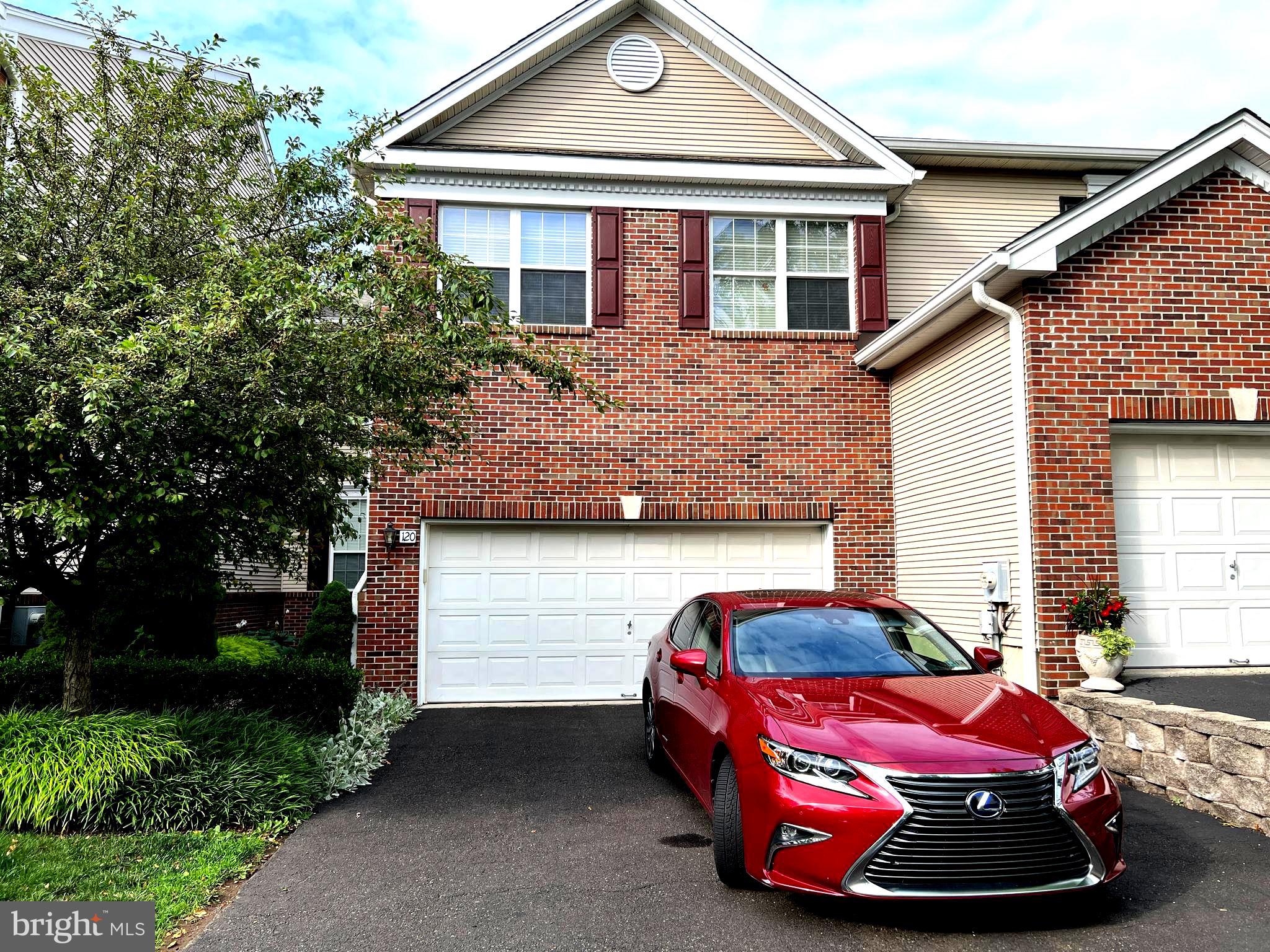 a front view of a house with parking space