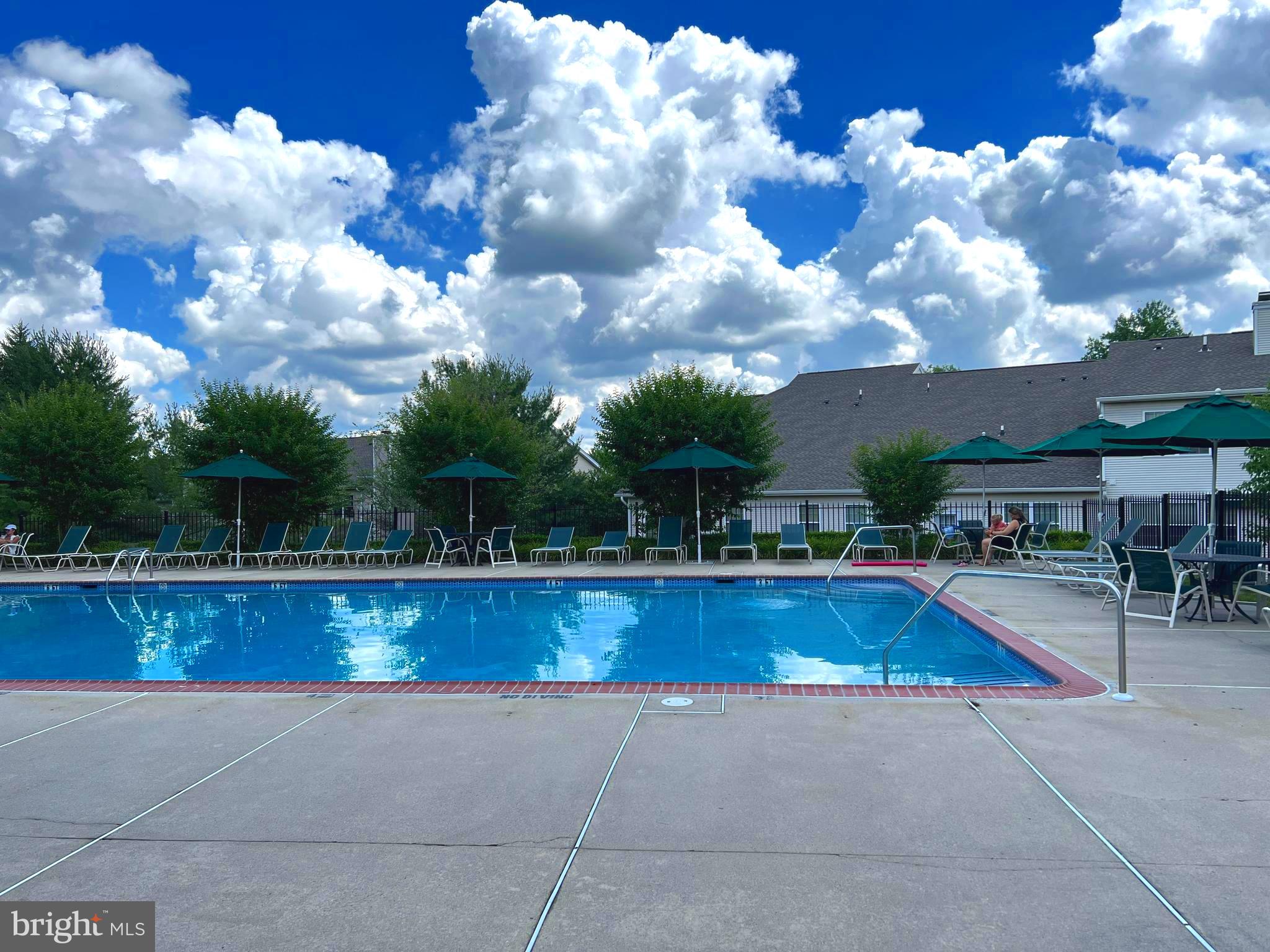 120 Dispatch Drive, Unit 77 Washington Crossing, PA 18977 - Photo 21 of 22 a view of swimming pool with seating space and trees in the background
