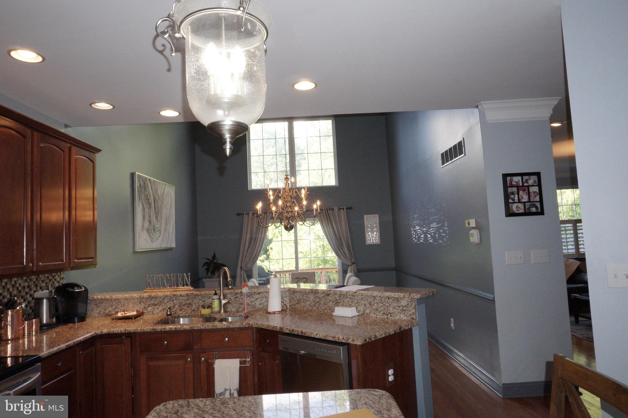 120 Dispatch Drive, Unit 77 Washington Crossing, PA 18977 - Photo 7 of 22 a kitchen with kitchen island granite countertop a sink cabinets and stainless steel appliances