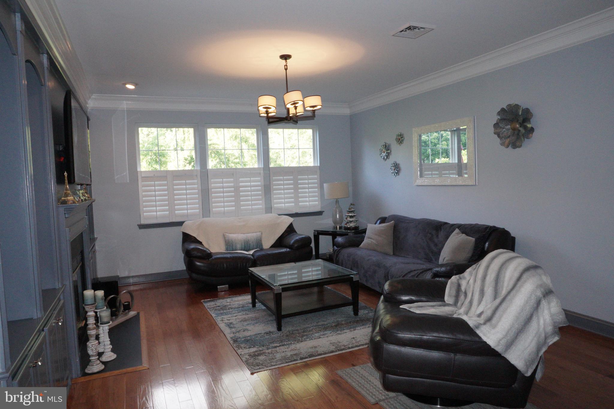 120 Dispatch Drive, Unit 77 Washington Crossing, PA 18977 - Photo 9 of 22 a living room with furniture chandelier and a window