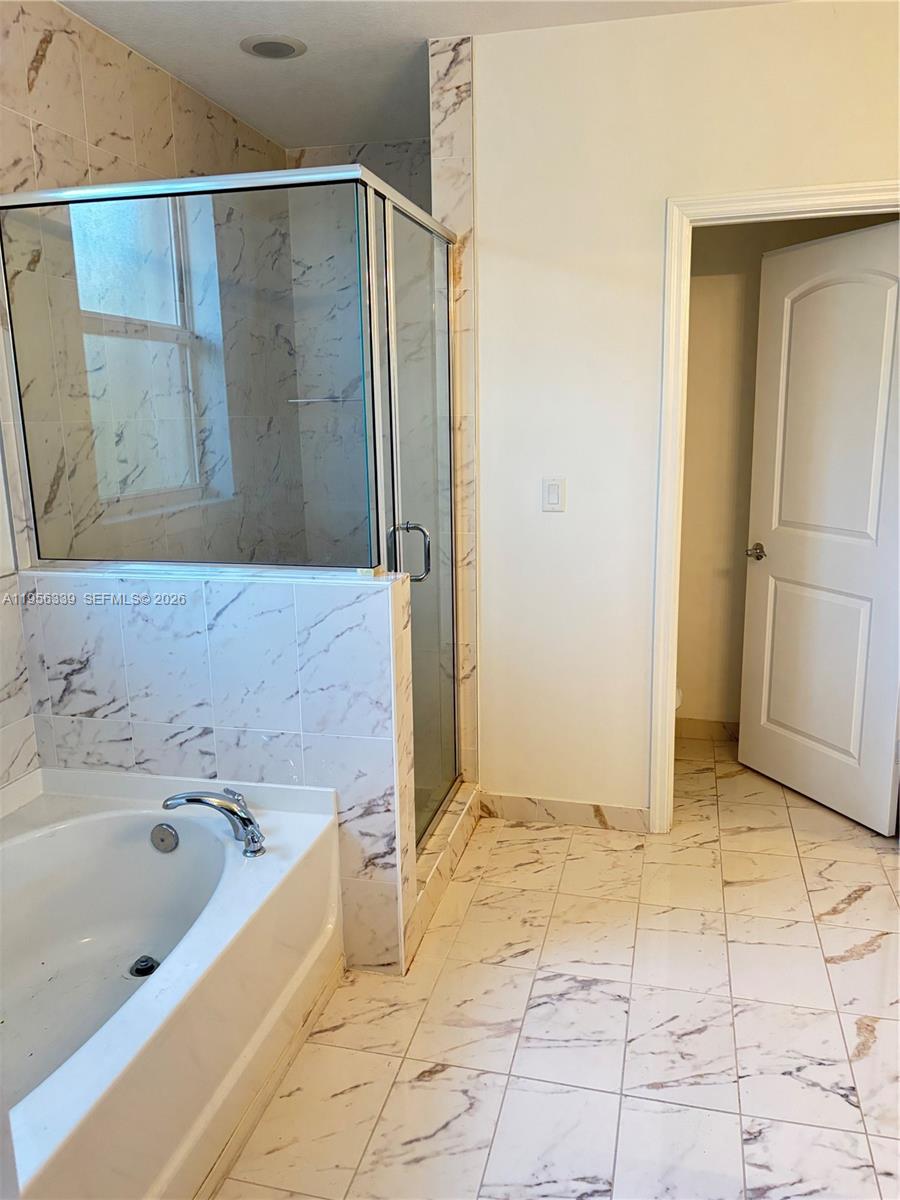 15041 Southwest 177th Terrace Miami, FL 33187 - Photo 11 of 12 a bathroom with a bathtub and a sink