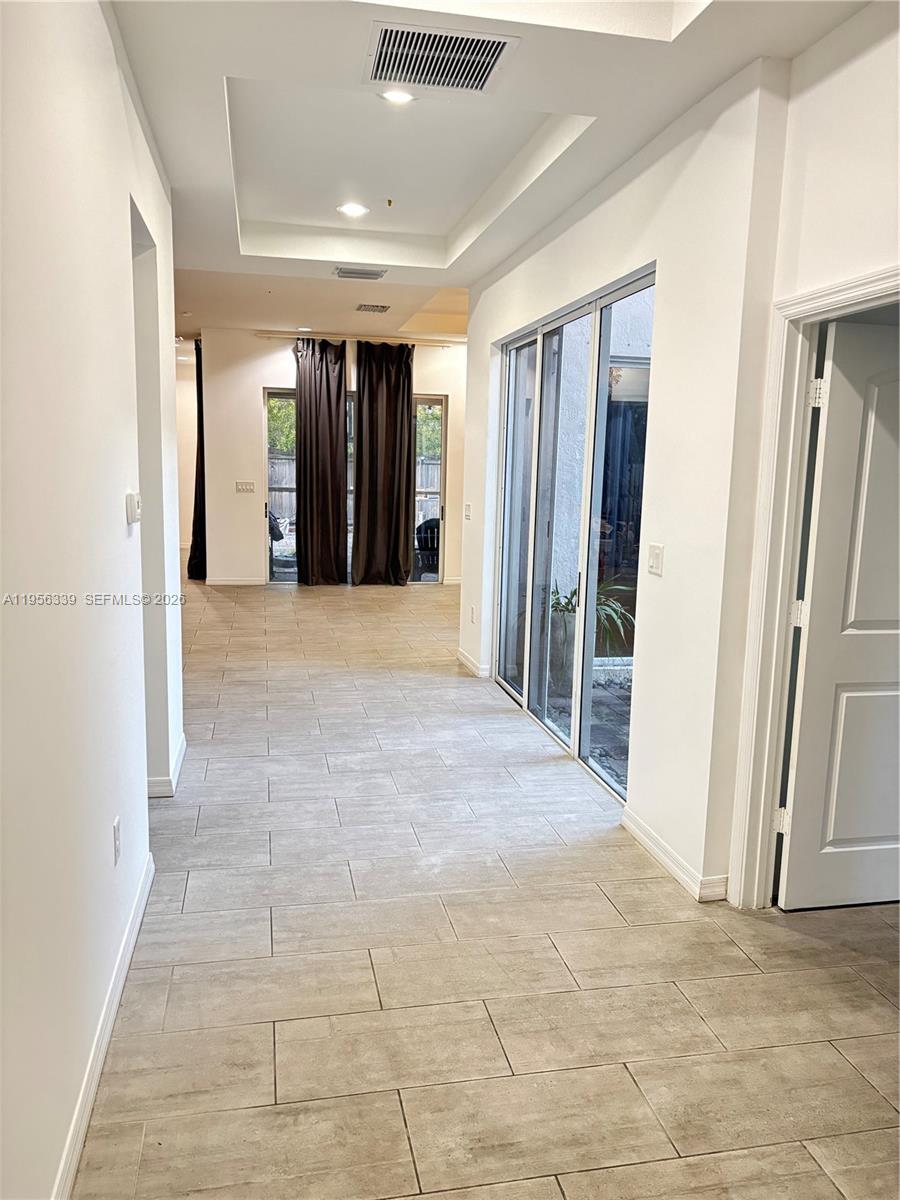 15041 Southwest 177th Terrace Miami, FL 33187 - Photo 2 of 12 a view of hallway with furniture and a refrigerator