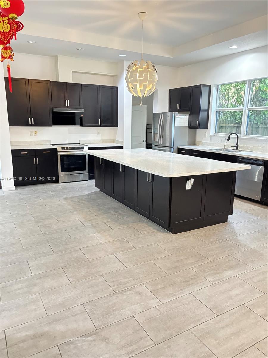 15041 Southwest 177th Terrace Miami, FL 33187 - Photo 5 of 12 a view of kitchen with microwave and cabinets