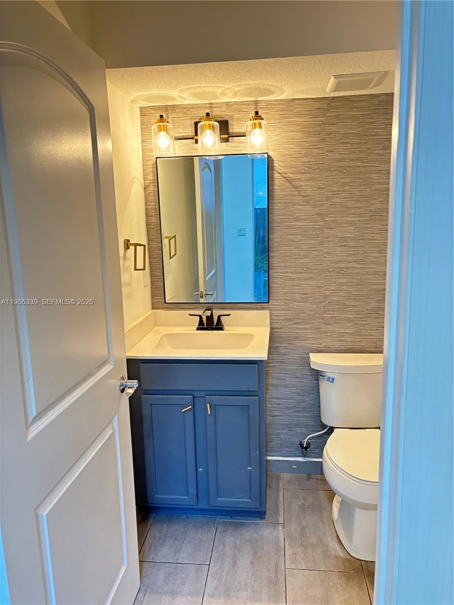 15041 Southwest 177th Terrace Miami, FL 33187 - Photo 7 of 12 a bathroom with a sink a toilet and shower