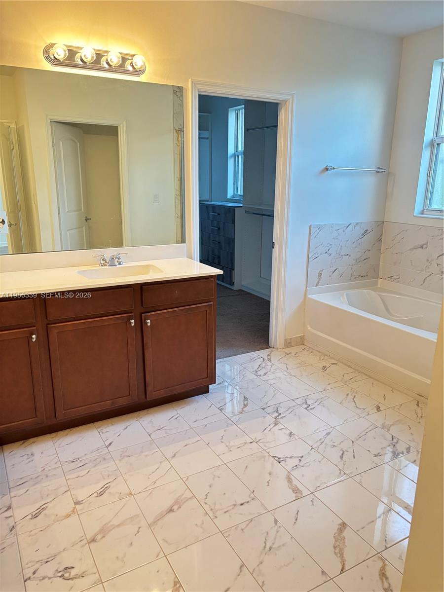 15041 Southwest 177th Terrace Miami, FL 33187 - Photo 10 of 12 a bathroom with a sink and a mirror