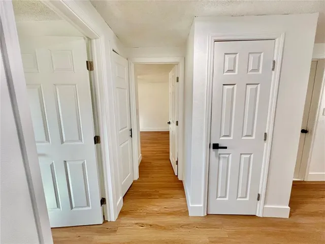 a view of a hallway with wooden floor