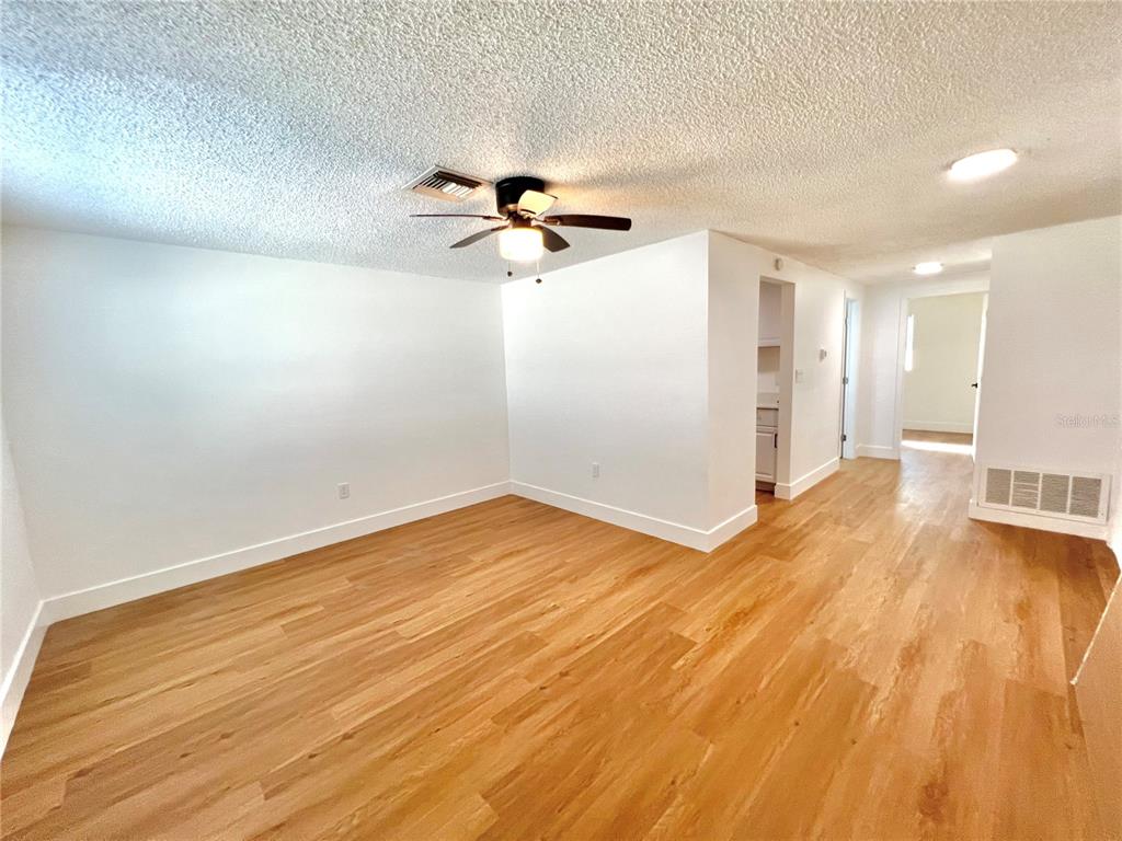 4930 Elkner Street New Port Richey, FL 34652 - Photo 2 of 17 wooden floor in an empty room with a window