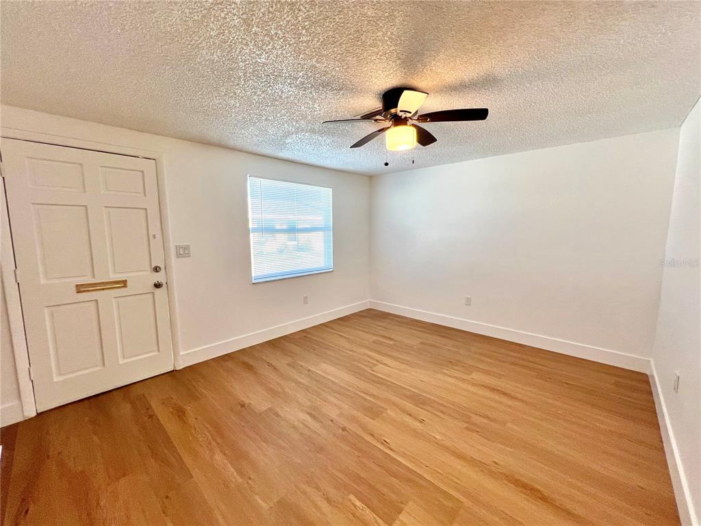 4930 Elkner Street New Port Richey, FL 34652 - Photo 4 of 17 wooden floor in an empty room