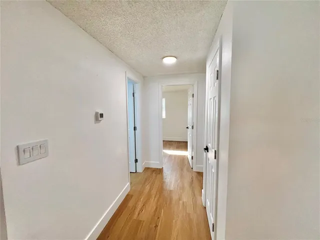 a view of a room with wooden floor