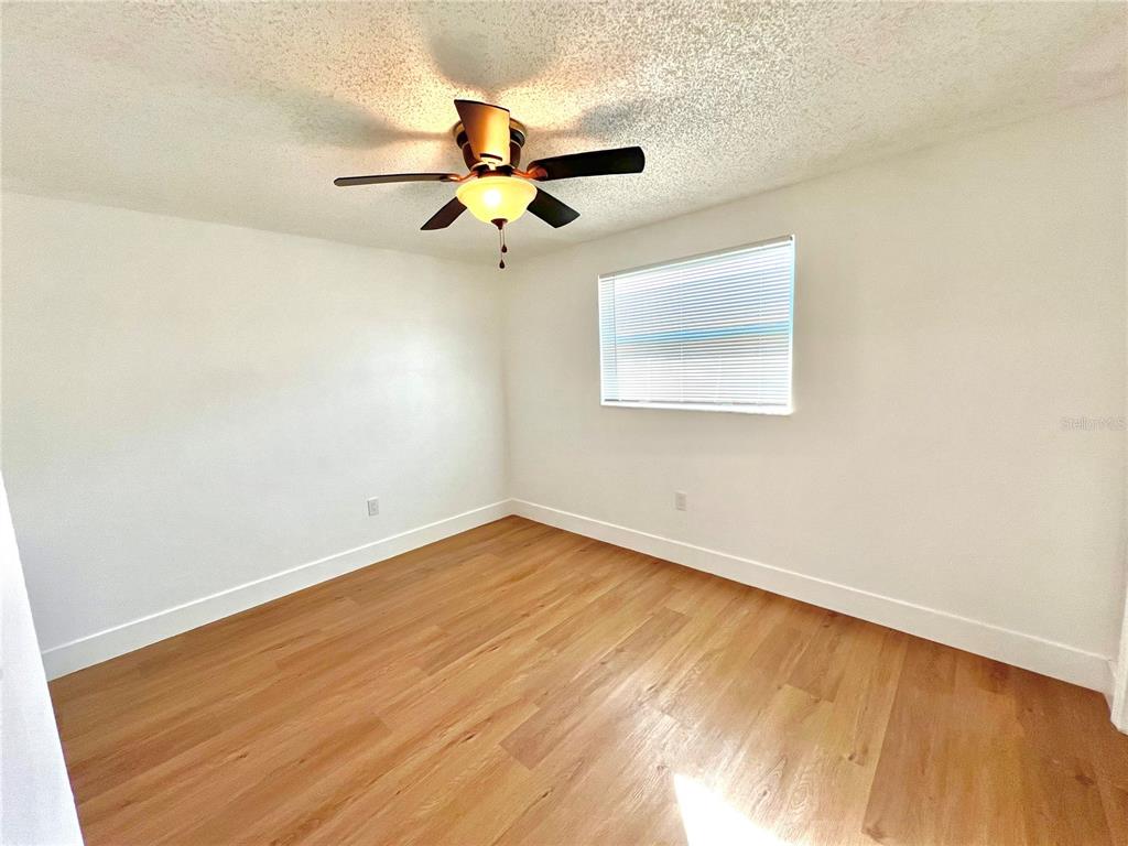 4930 Elkner Street New Port Richey, FL 34652 - Photo 9 of 17 an empty room with a window and a ceiling fan