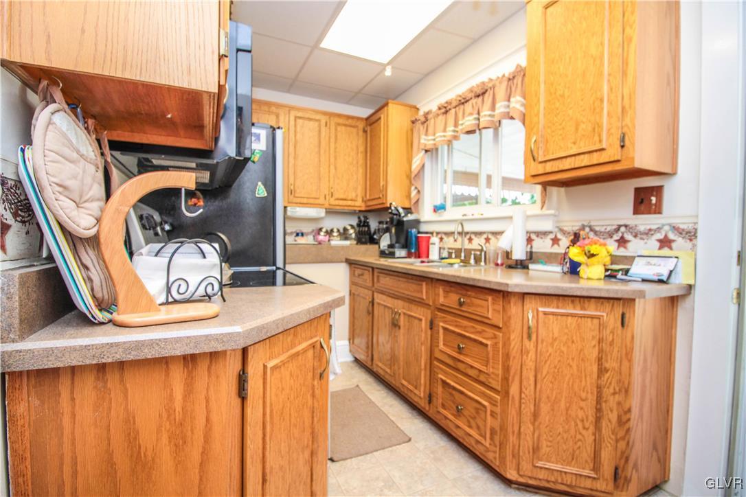 1139 Spring Garden Street Easton, PA 18042 - Photo 13 of 26 a kitchen with stainless steel appliances granite countertop a sink a stove and a refrigerator