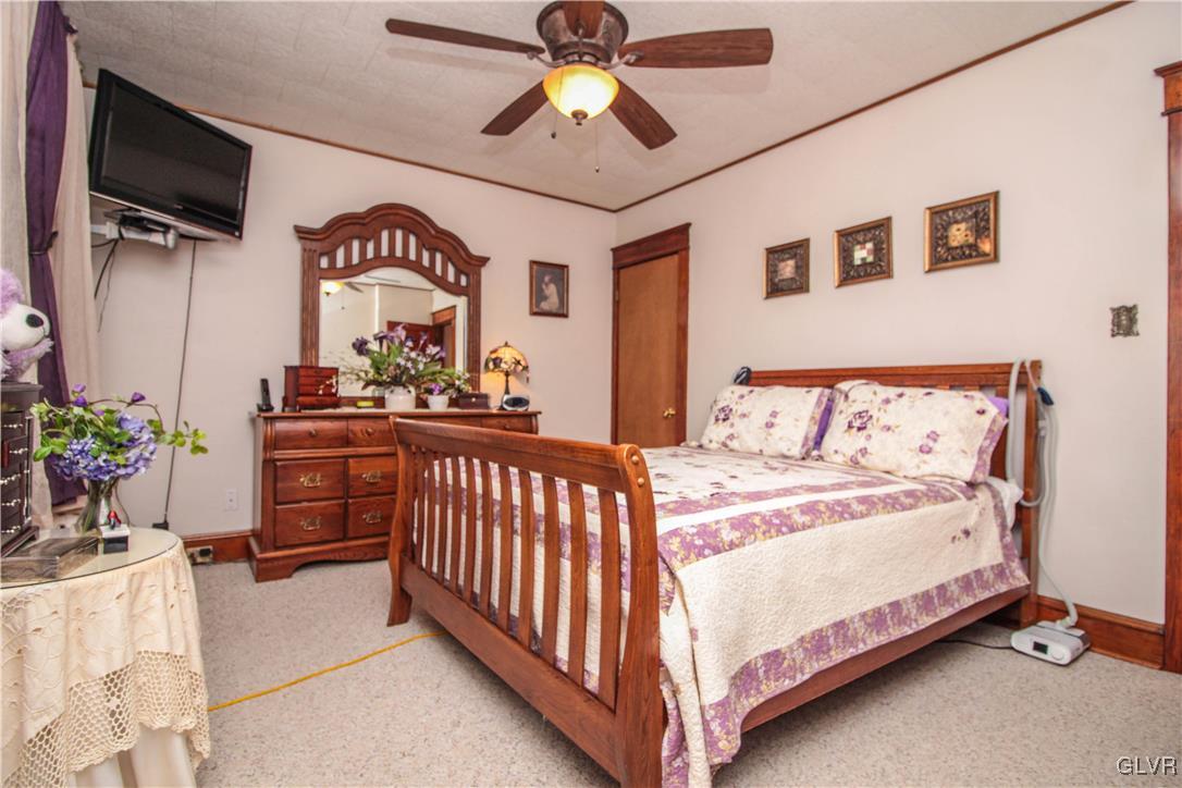 1139 Spring Garden Street Easton, PA 18042 - Photo 15 of 26 a bedroom with a bed and a chandelier