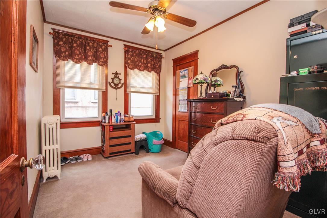 1139 Spring Garden Street Easton, PA 18042 - Photo 18 of 26 a bedroom with a bed and a chandelier