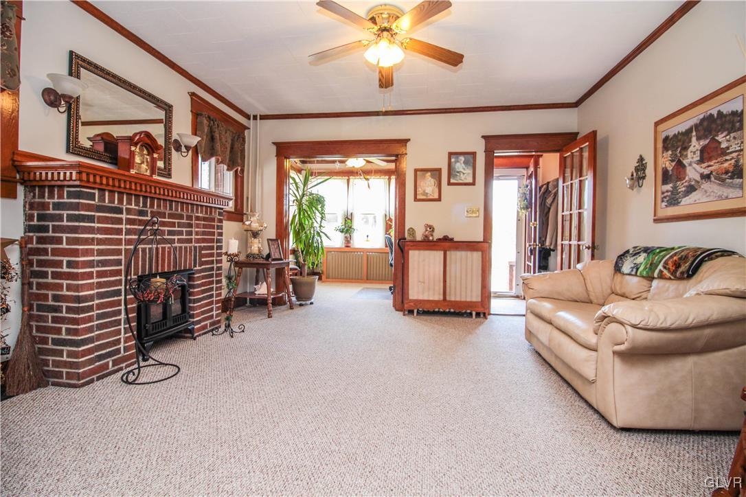 1139 Spring Garden Street Easton, PA 18042 - Photo 2 of 26 a living room with furniture and a chandelier