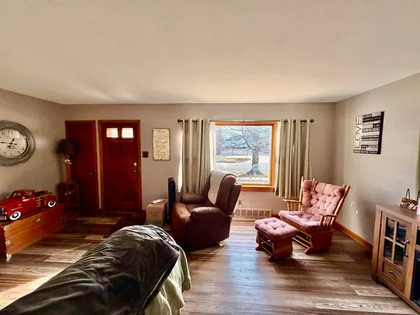a bedroom with furniture and wooden floor