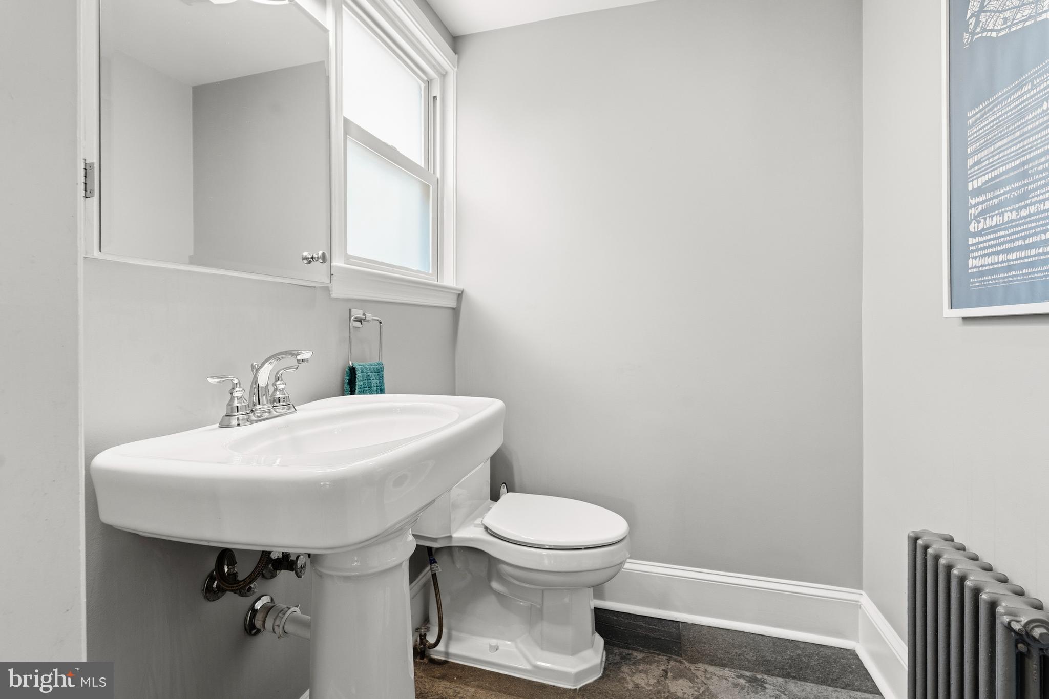 148 Todd Place Northeast Washington, DC 20002 - Photo 12 of 43 a bathroom with a sink a toilet and a mirror