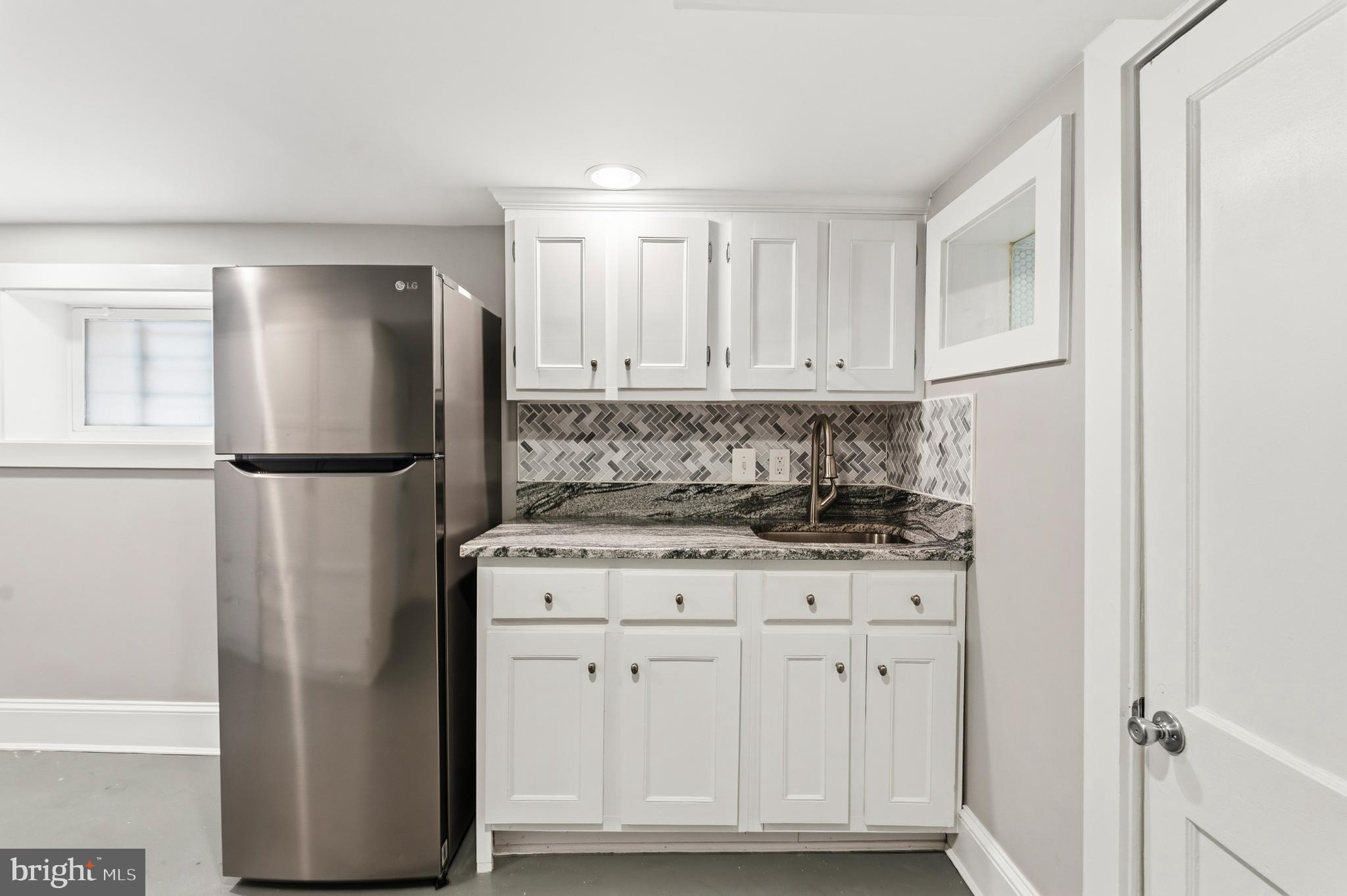 148 Todd Place Northeast Washington, DC 20002 - Photo 29 of 43 a kitchen with stainless steel appliances granite countertop a refrigerator a stove a sink and white cabinets