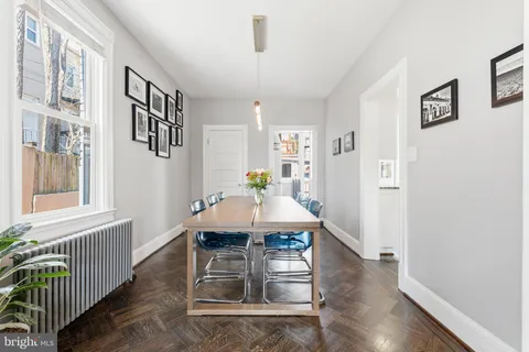 a view of a dining room with furniture and wooden floor