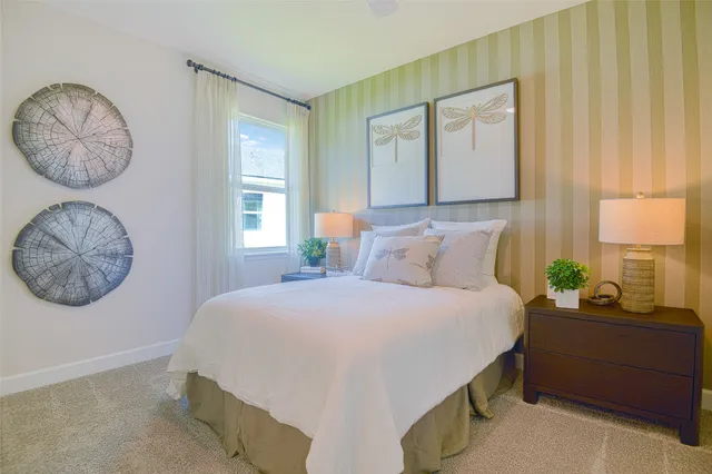 a bedroom with a bed a mirror and a window