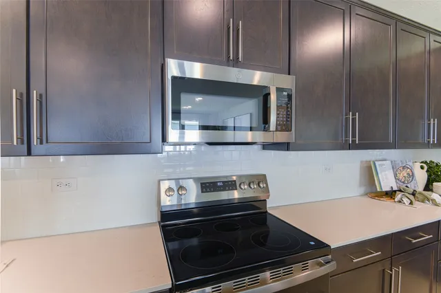 a kitchen with a sink cabinets and stainless steel appliances