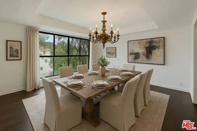 a kitchen with granite countertop a stove a sink and a white wooden cabinets