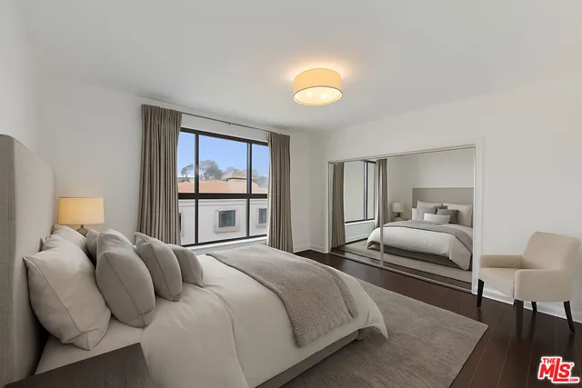 a bedroom with a large bed and a window