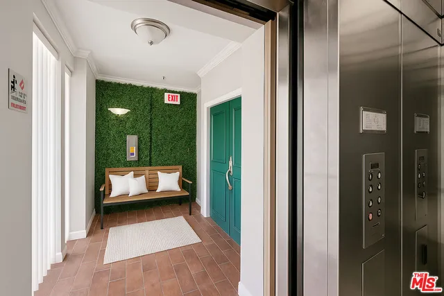 a living room with furniture and a balcony